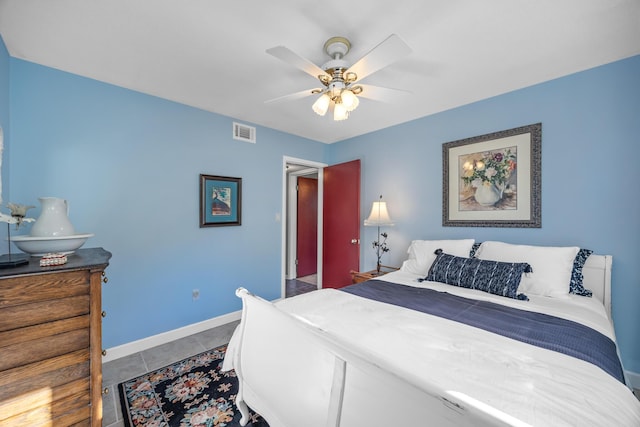 tiled bedroom featuring ceiling fan