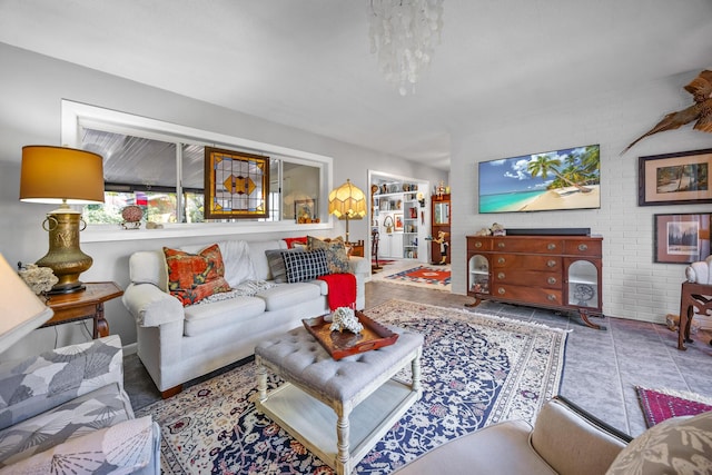 tiled living room featuring brick wall