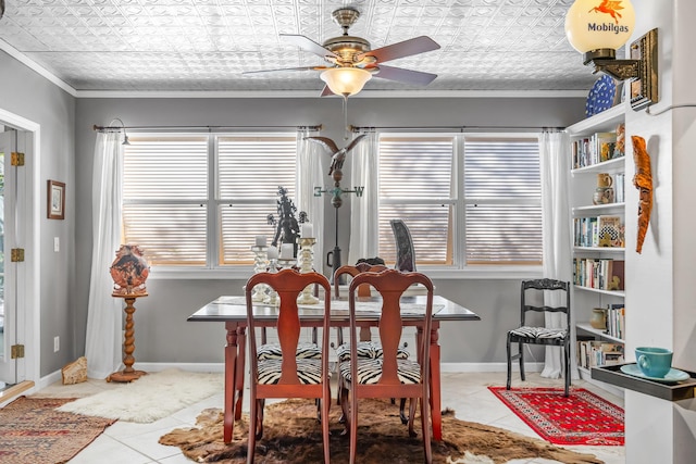 tiled dining space featuring ornamental molding and ceiling fan