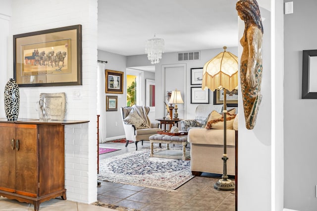 living room featuring tile patterned flooring and a chandelier