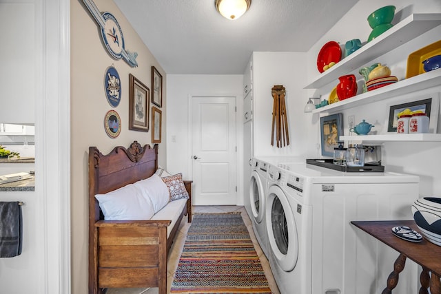 washroom featuring dark tile patterned flooring, independent washer and dryer, and a textured ceiling