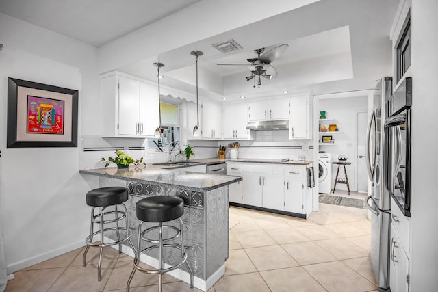 kitchen featuring white cabinetry, hanging light fixtures, a kitchen breakfast bar, light tile patterned flooring, and kitchen peninsula