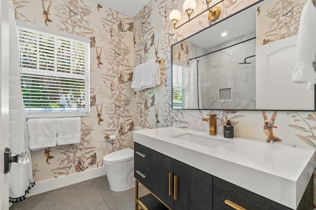 bathroom featuring vanity, toilet, and walk in shower