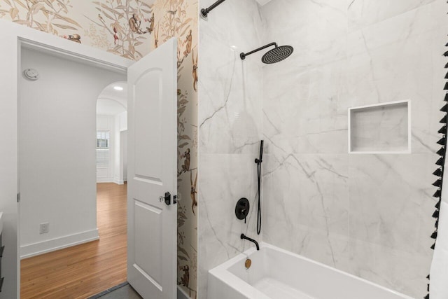 bathroom featuring tiled shower / bath and wood-type flooring