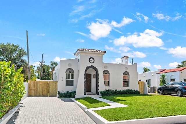 mediterranean / spanish-style house with a front yard