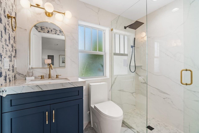 bathroom with vanity, toilet, an enclosed shower, and a wealth of natural light