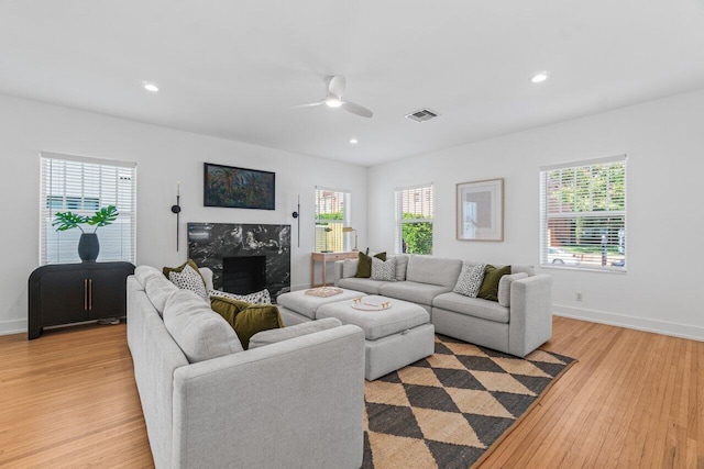 living room featuring ceiling fan and light hardwood / wood-style floors