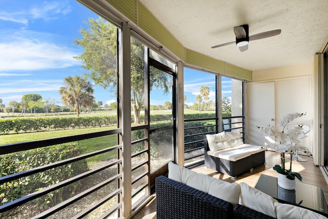 sunroom / solarium featuring ceiling fan