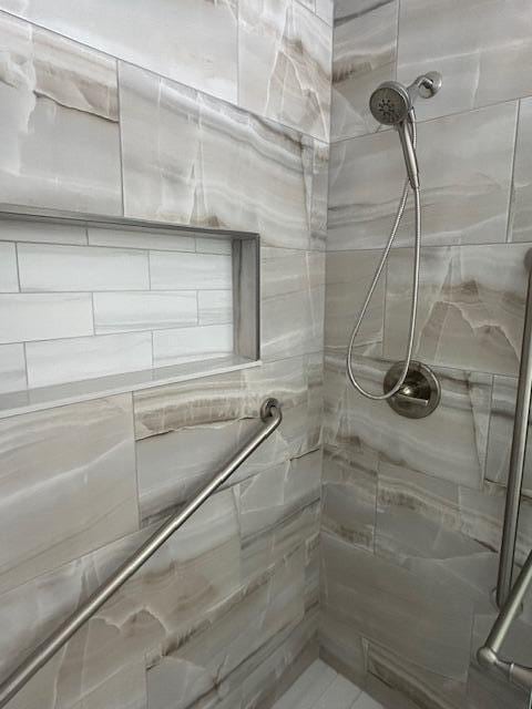 bathroom with a tile shower