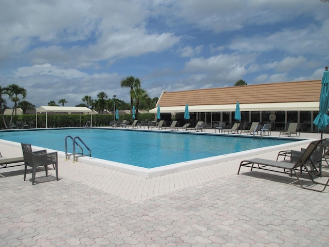 community pool featuring a patio area