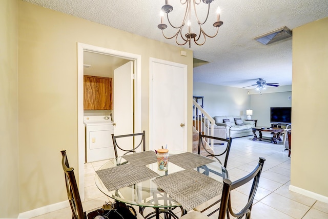 dining area with light tile patterned flooring, washer / clothes dryer, ceiling fan with notable chandelier, and a textured ceiling