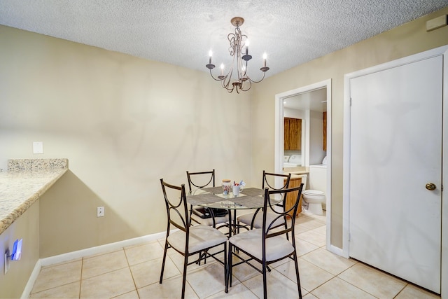 tiled dining space with an inviting chandelier and a textured ceiling