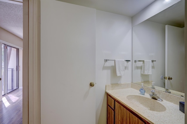 bathroom with vanity and hardwood / wood-style floors