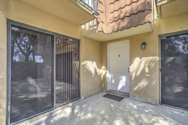 property entrance featuring a patio area