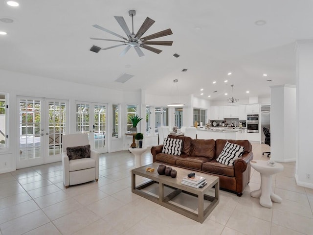 living room featuring lofted ceiling, light tile patterned floors, and french doors