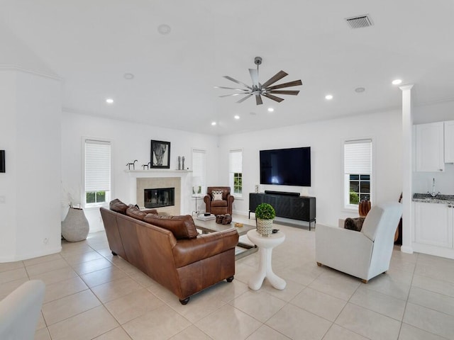 living room with light tile patterned floors and ceiling fan