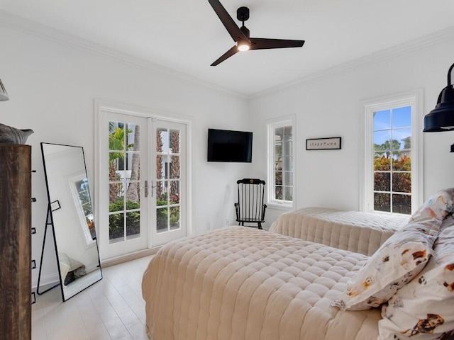 bedroom featuring ornamental molding, light hardwood / wood-style floors, and multiple windows