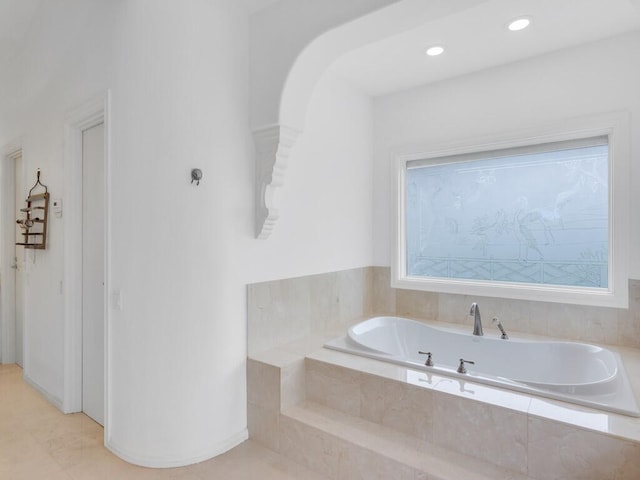 bathroom featuring tiled tub