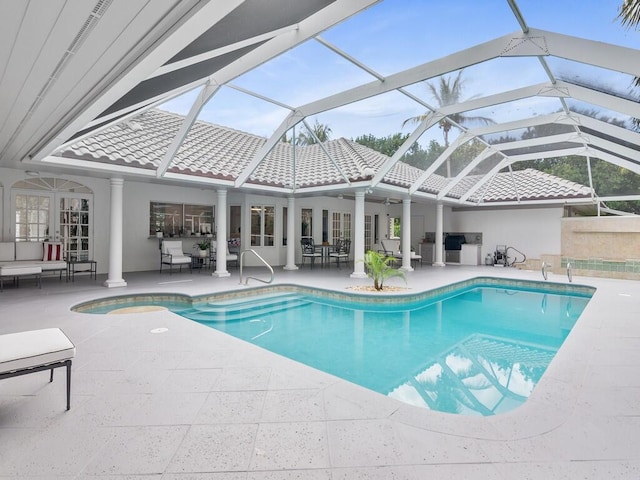 view of swimming pool with french doors, a patio area, and glass enclosure