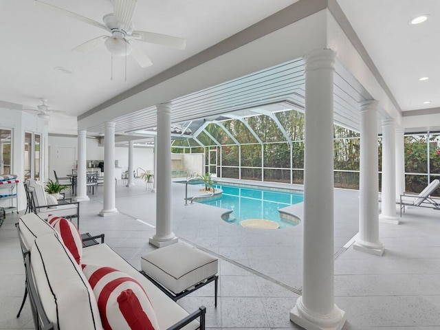 view of pool with decorative columns and ceiling fan