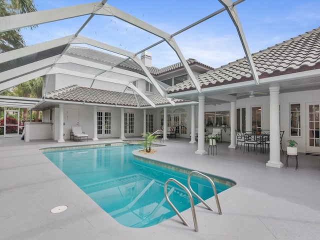 view of swimming pool with a lanai, a patio area, and ceiling fan