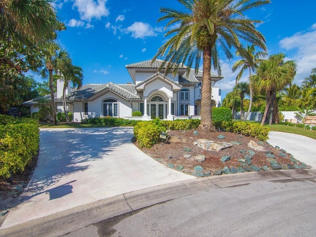 mediterranean / spanish-style house featuring french doors