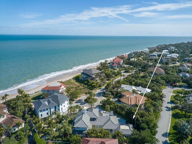 birds eye view of property featuring a water view and a beach view