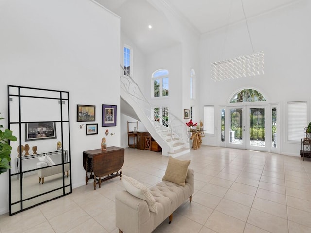 tiled living room with a high ceiling, a wealth of natural light, and french doors