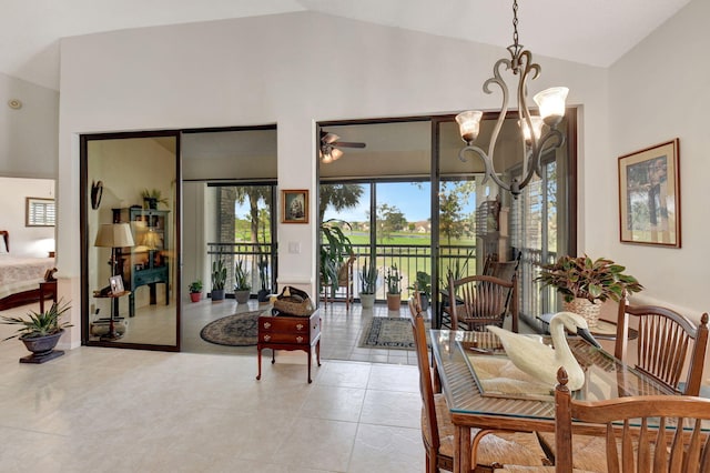 interior space featuring vaulted ceiling, ceiling fan with notable chandelier, and light tile patterned floors