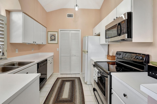 kitchen featuring pendant lighting, sink, appliances with stainless steel finishes, white cabinets, and vaulted ceiling