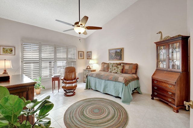 bedroom with light tile patterned flooring, high vaulted ceiling, ceiling fan, and a textured ceiling