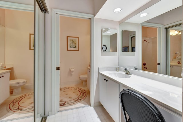 bathroom with vanity, tile patterned floors, and toilet