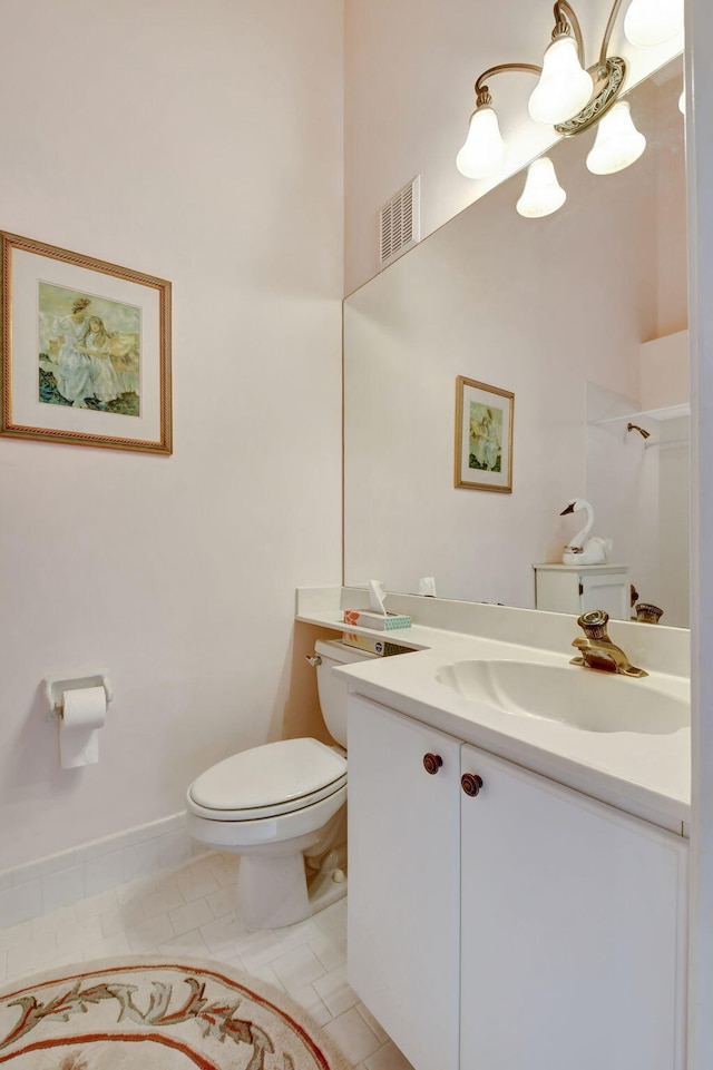 bathroom with vanity, tile patterned floors, and toilet