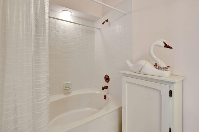 bathroom with shower / bath combo with shower curtain