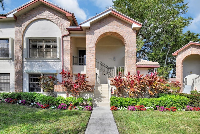 mediterranean / spanish home with a front yard