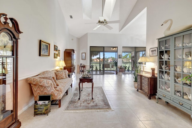 living room featuring light tile patterned floors, high vaulted ceiling, and ceiling fan