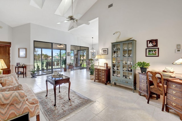 living room featuring high vaulted ceiling, ceiling fan with notable chandelier, and light tile patterned floors