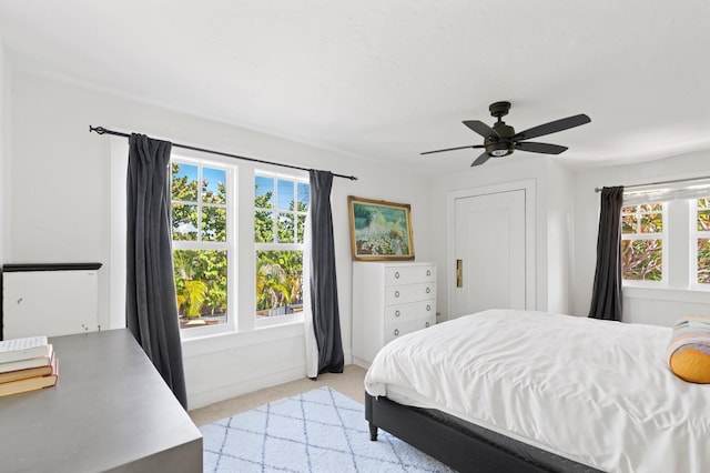 carpeted bedroom featuring ceiling fan