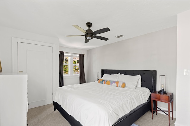 bedroom featuring light colored carpet and ceiling fan