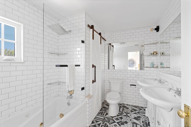 full bathroom with sink, tile walls, tiled shower / bath, tile patterned floors, and toilet