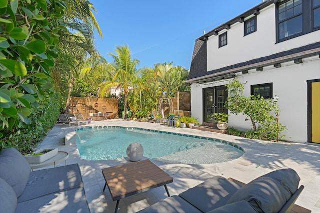 view of pool featuring pool water feature and a patio