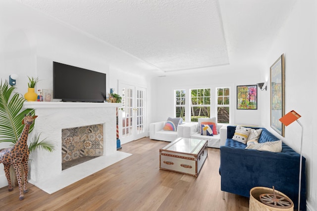 living room featuring a textured ceiling and light wood-type flooring