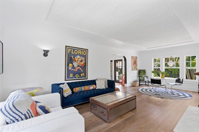 living room with wood-type flooring and a textured ceiling