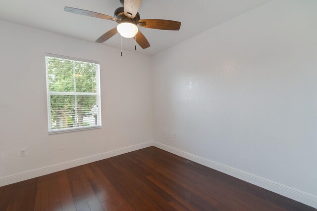 unfurnished room with ceiling fan and dark hardwood / wood-style flooring