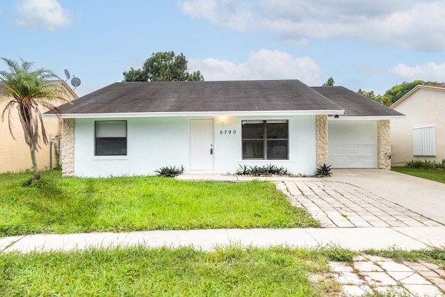 ranch-style house featuring a garage and a front lawn