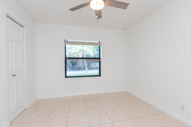 unfurnished room featuring light tile patterned floors and ceiling fan