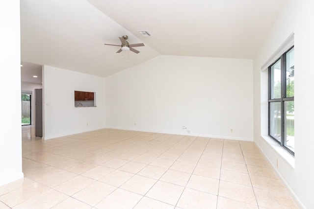 unfurnished room with lofted ceiling, light tile patterned floors, and ceiling fan