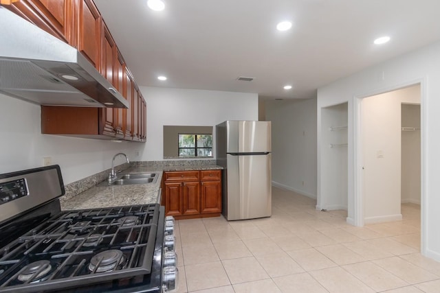 kitchen with sink, light tile patterned floors, and appliances with stainless steel finishes