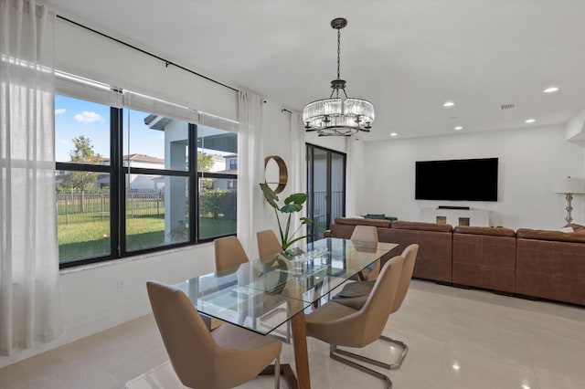 dining area featuring an inviting chandelier and light tile patterned floors