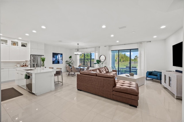 living room featuring sink and a notable chandelier